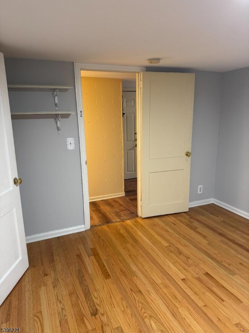656 Highway 12, Unit 4 Flemington, NJ 08822 - Photo 12 of 16 a view of an empty room with wooden floor and a window