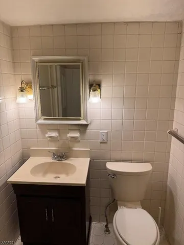 a bathroom with a sink toilet and mirror
