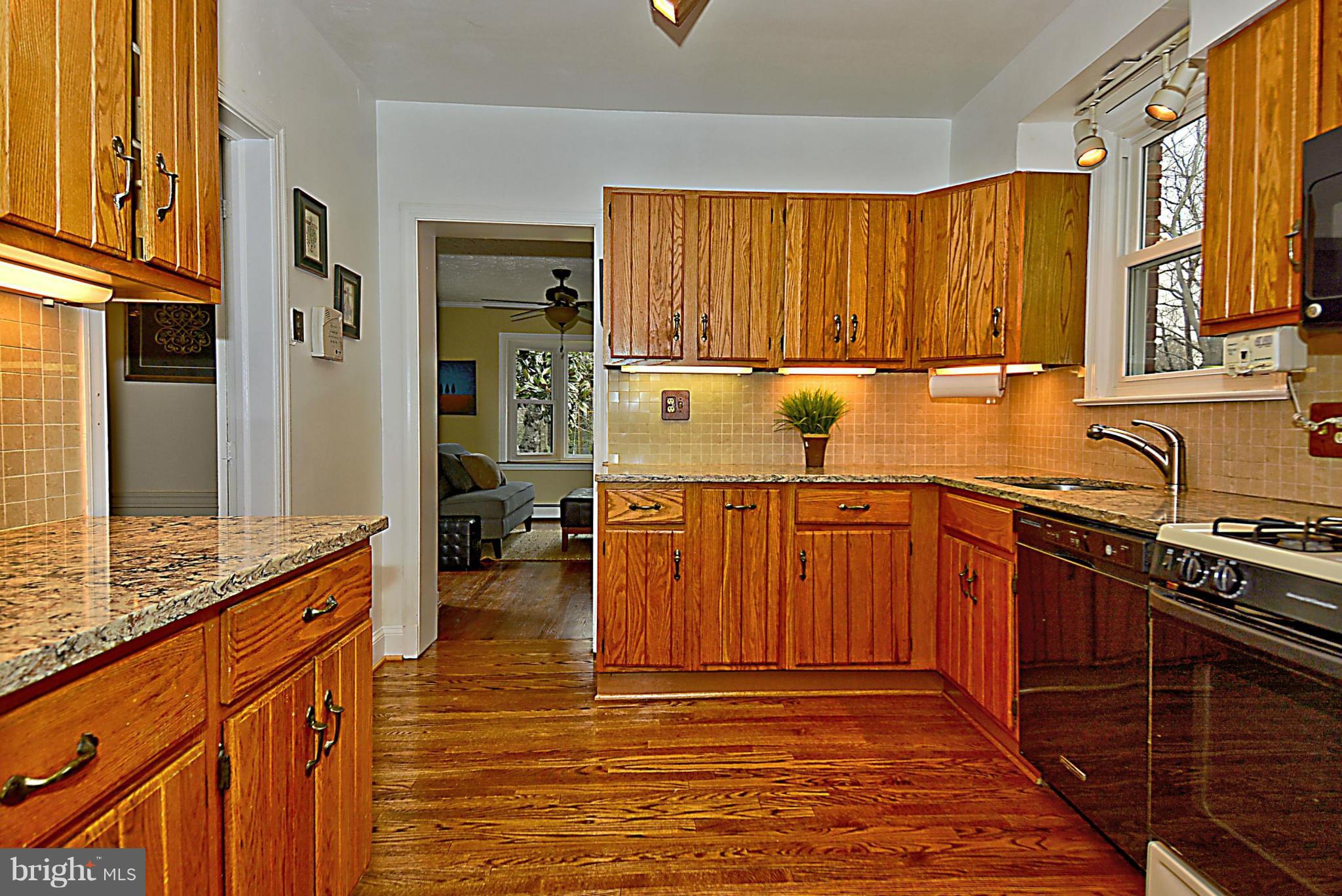 1111 Woodside Parkway Silver Spring, MD 20910 - Photo 11 of 30 a kitchen with stainless steel appliances granite countertop a sink stove and cabinets