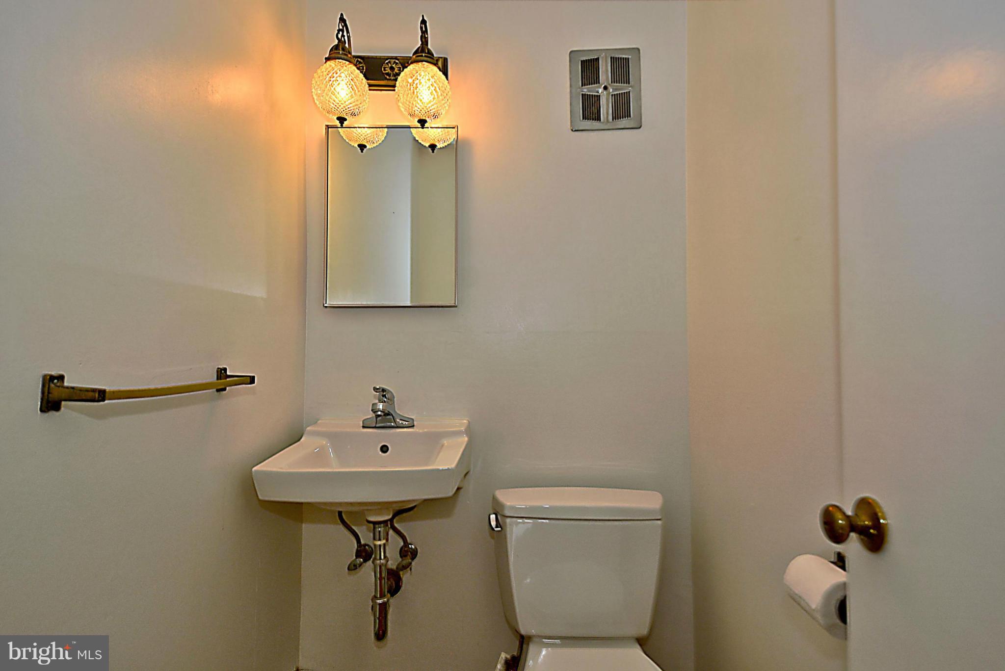 1111 Woodside Parkway Silver Spring, MD 20910 - Photo 14 of 30 a bathroom with a sink mirror and toilet