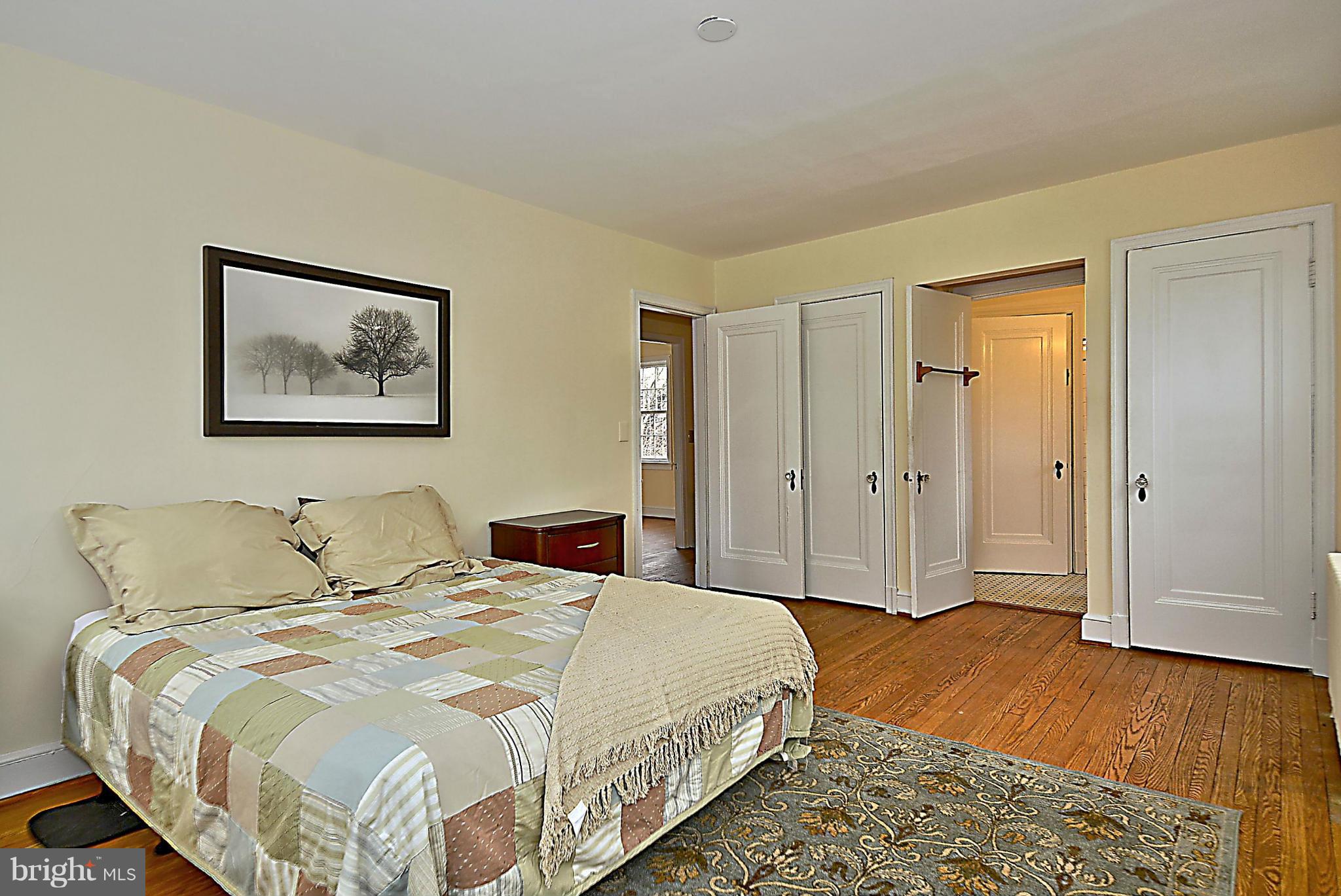 1111 Woodside Parkway Silver Spring, MD 20910 - Photo 16 of 30 a bedroom with a bed and a painting on the wall