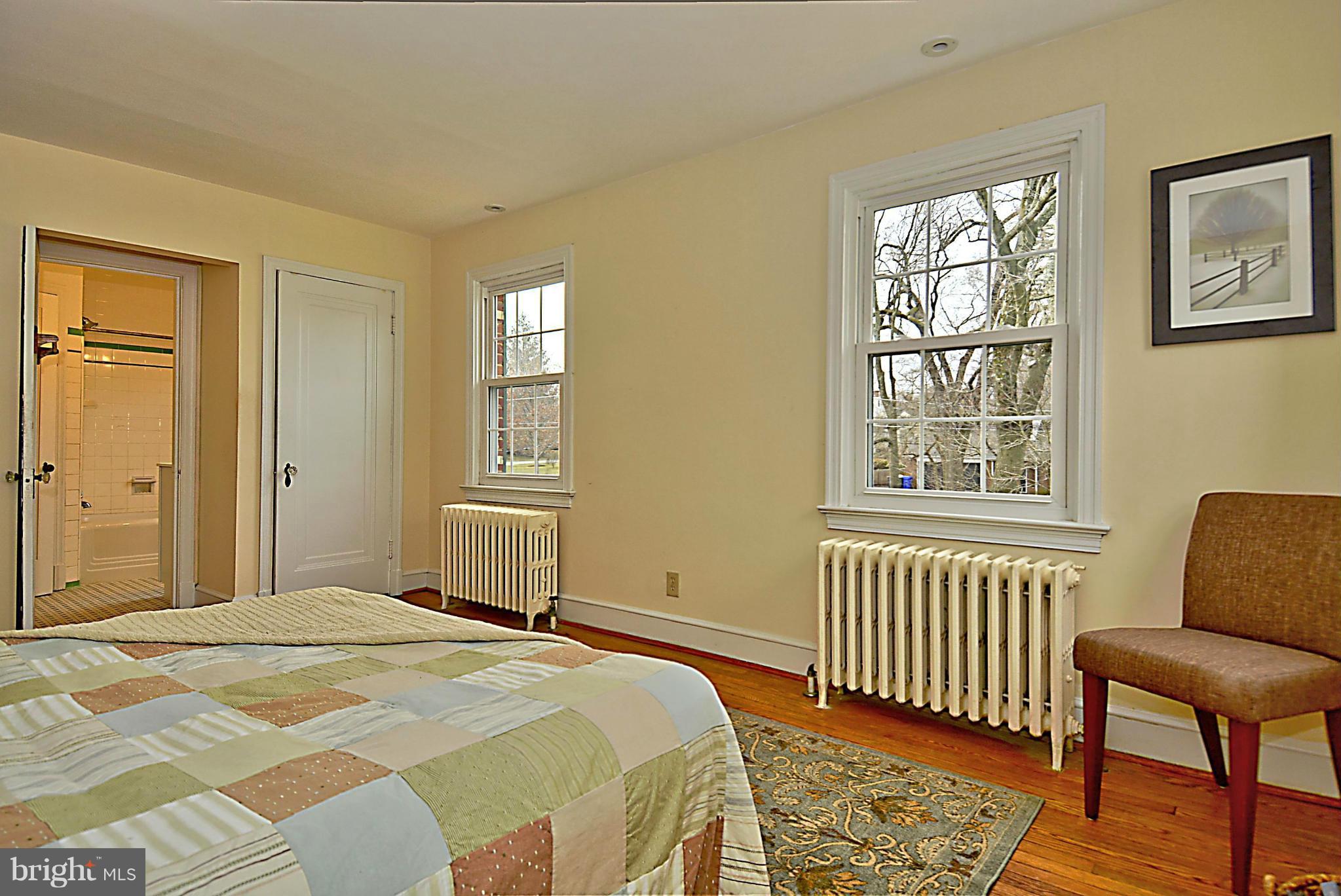 1111 Woodside Parkway Silver Spring, MD 20910 - Photo 18 of 30 a bedroom with a bed and wooden floor