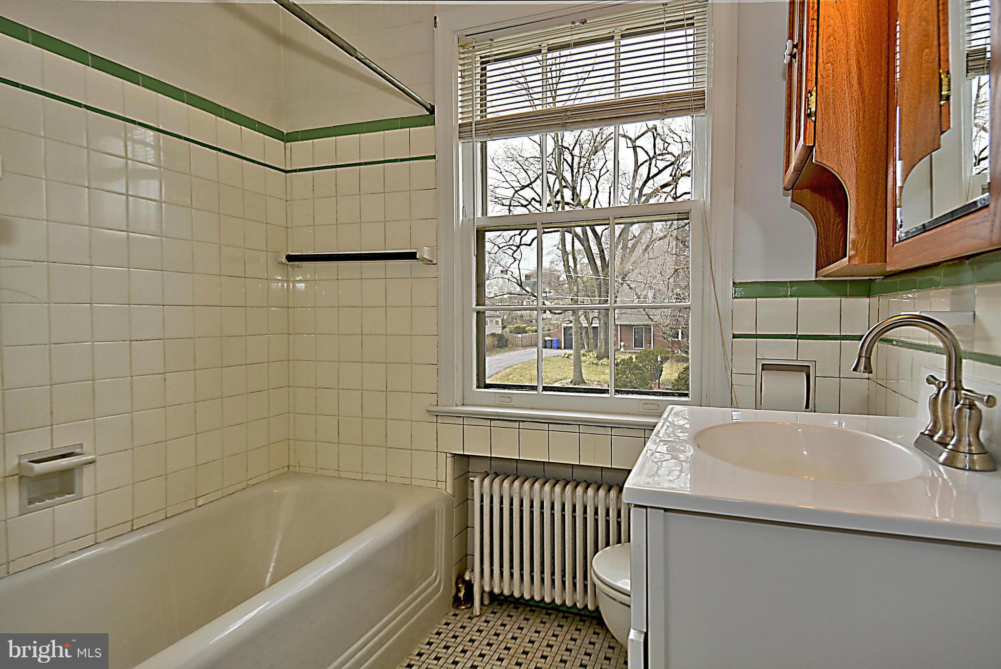1111 Woodside Parkway Silver Spring, MD 20910 - Photo 19 of 30 a bathroom with a sink and a bathtub