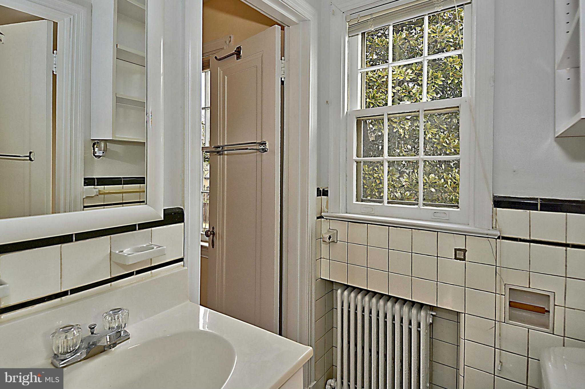1111 Woodside Parkway Silver Spring, MD 20910 - Photo 20 of 30 a bathroom with a shower and a sink