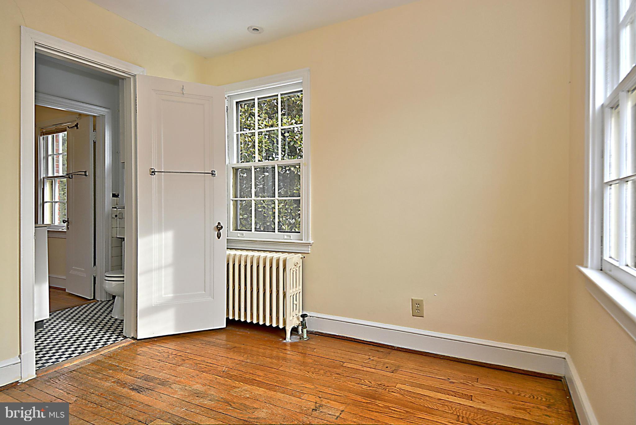 1111 Woodside Parkway Silver Spring, MD 20910 - Photo 22 of 30 an empty room with wooden floor and windows