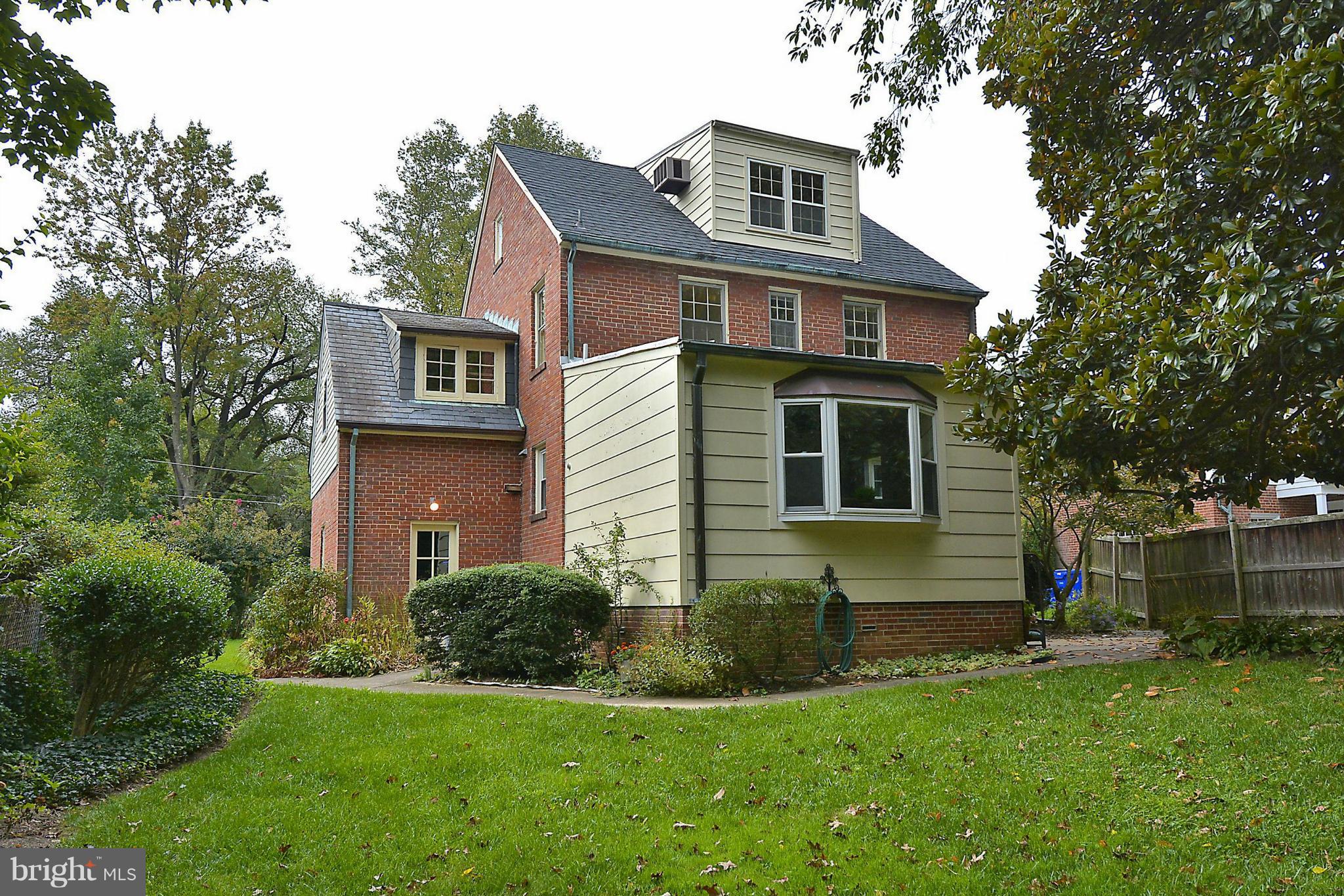 1111 Woodside Parkway Silver Spring, MD 20910 - Photo 28 of 30 a front view of a house with a garden