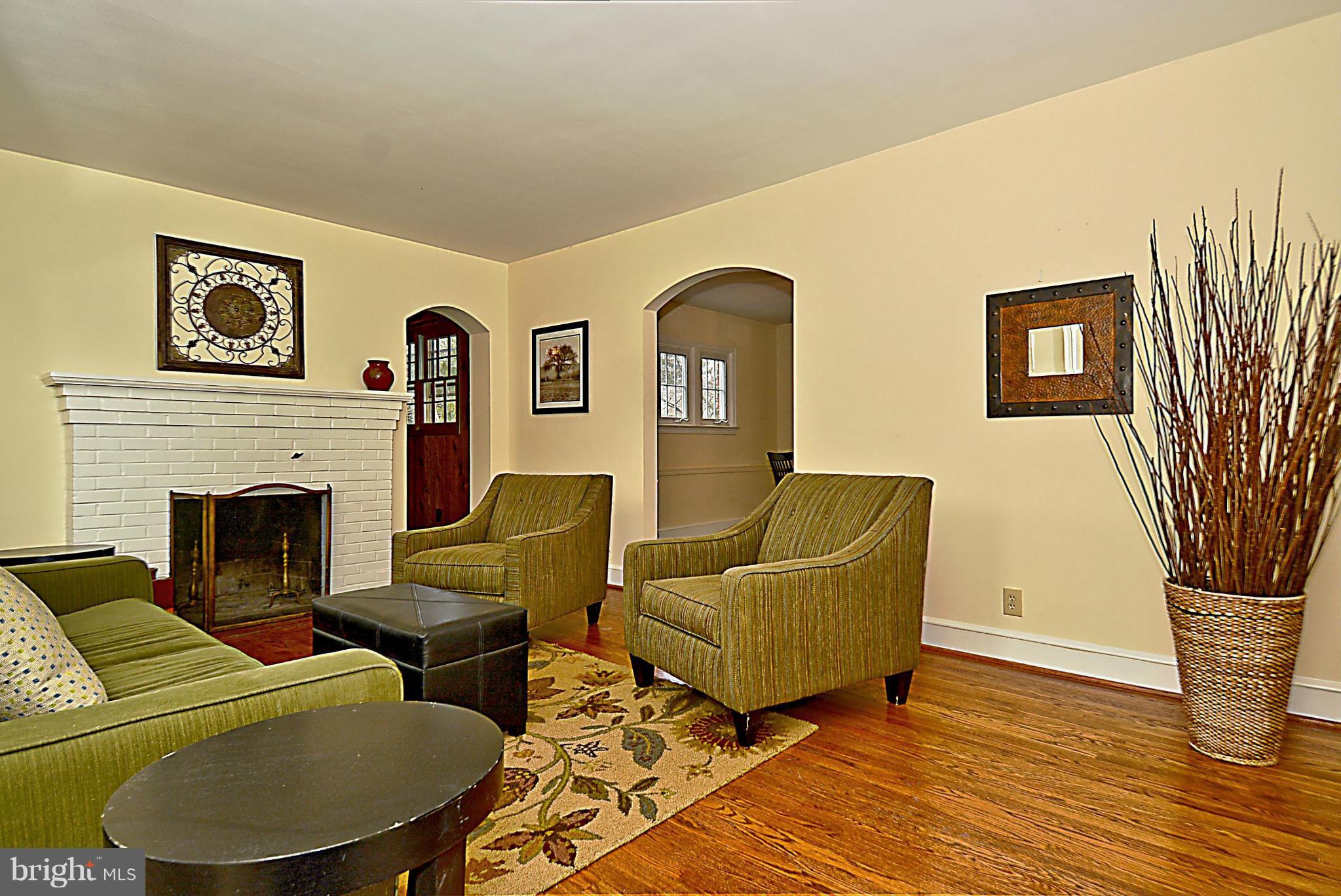1111 Woodside Parkway Silver Spring, MD 20910 - Photo 6 of 30 a living room with furniture and a fireplace