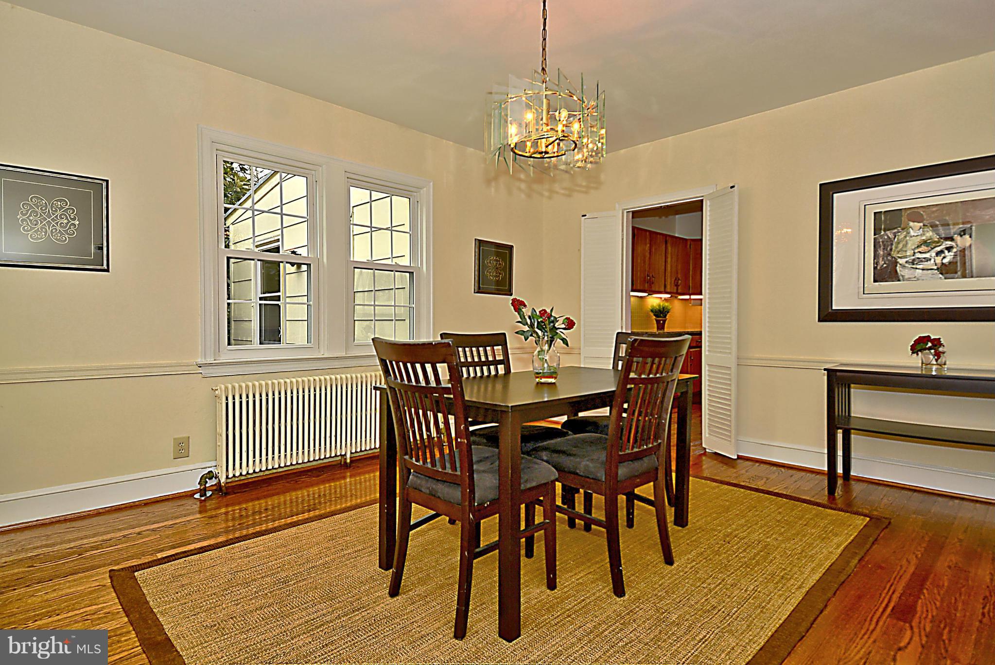 1111 Woodside Parkway Silver Spring, MD 20910 - Photo 8 of 30 a view of a dining room with furniture a chandelier and wooden floor
