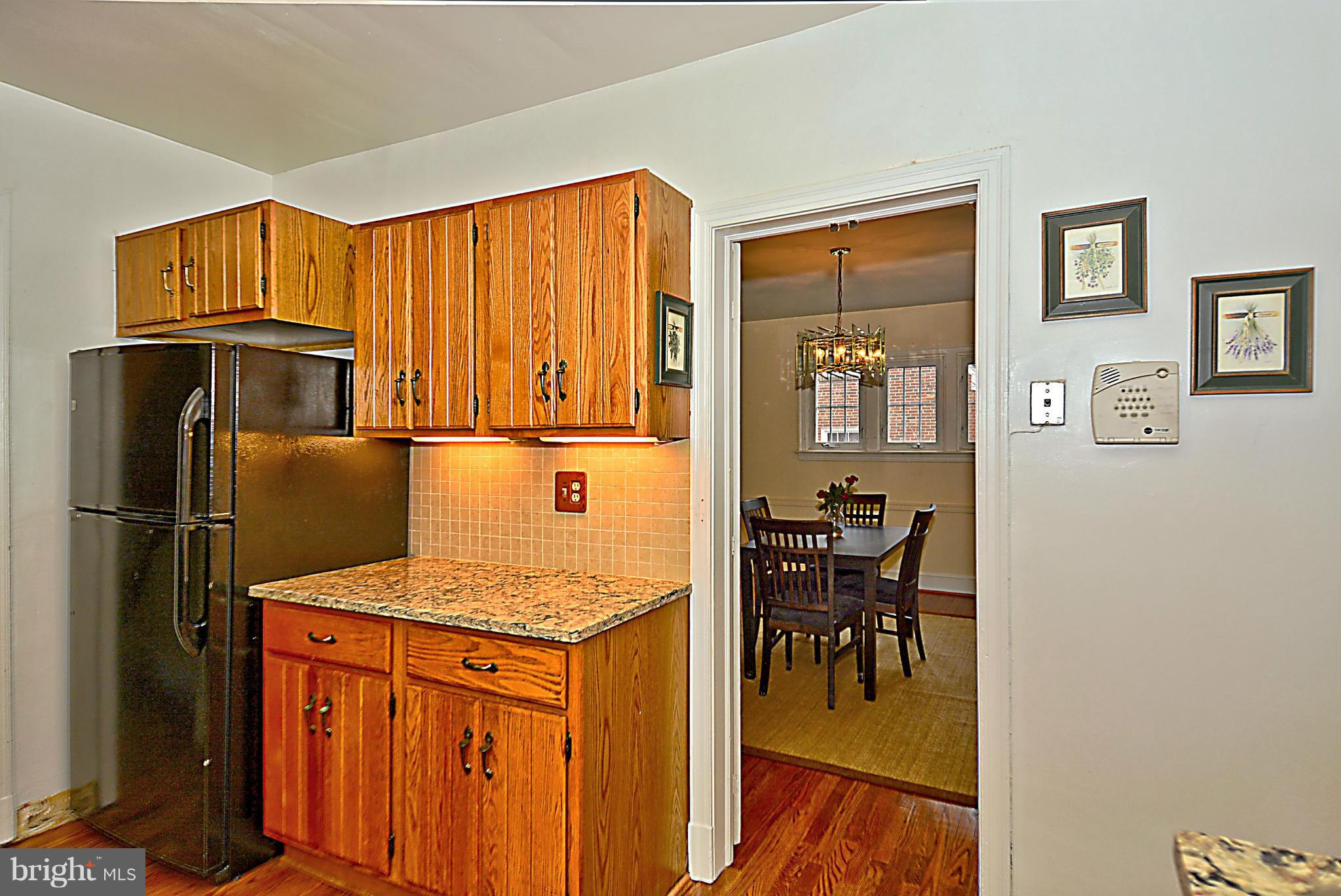 1111 Woodside Parkway Silver Spring, MD 20910 - Photo 9 of 30 a kitchen with stainless steel appliances granite countertop a refrigerator and a stove top oven