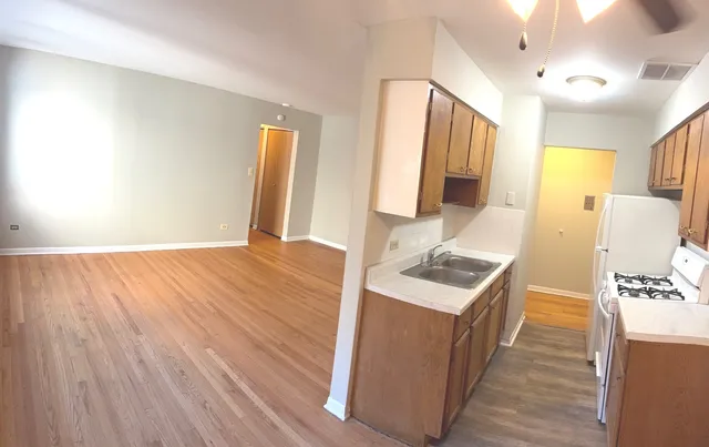 a kitchen with a wooden floor and a stove top oven