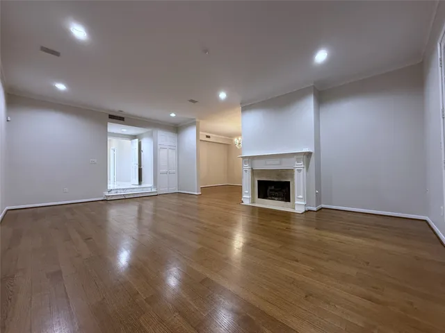 a view of an empty room with a fireplace and a window