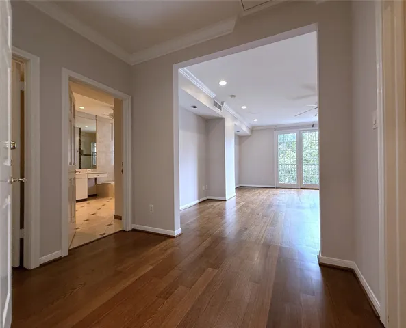 a view of empty room with wooden floor and window