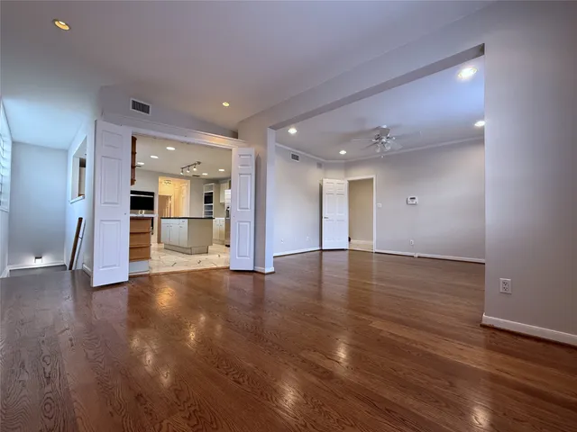 a large kitchen with stainless steel appliances kitchen island granite countertop a large counter top space and cabinets