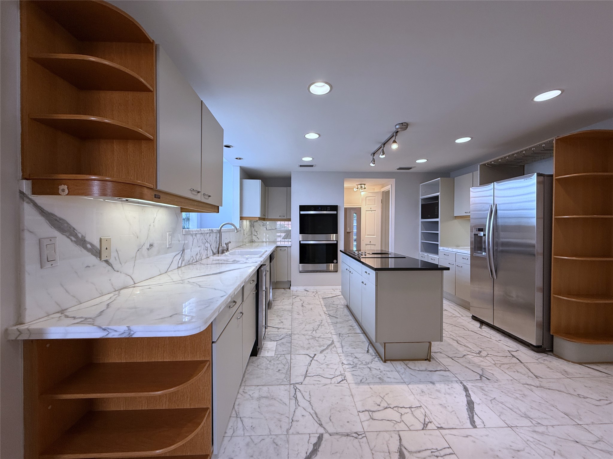 2813 Saint Street Houston, TX 77027 - Photo 8 of 39 The kitchen features marble counter tops and marble flooring, recessed lighting, track lighting and under-cabinet lighting.