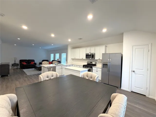 a living room with furniture and kitchen view