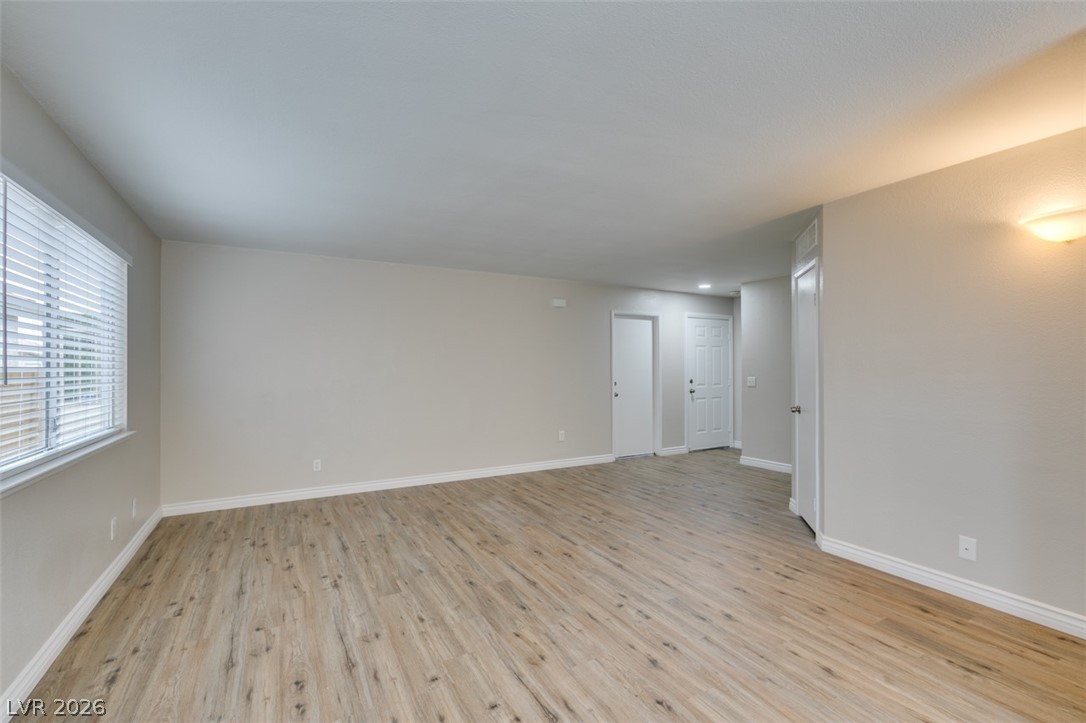 905 Scarlet Ridge Drive Las Vegas, NV 89128 - Photo 11 of 39 Unfurnished room featuring light wood-style floors and baseboards