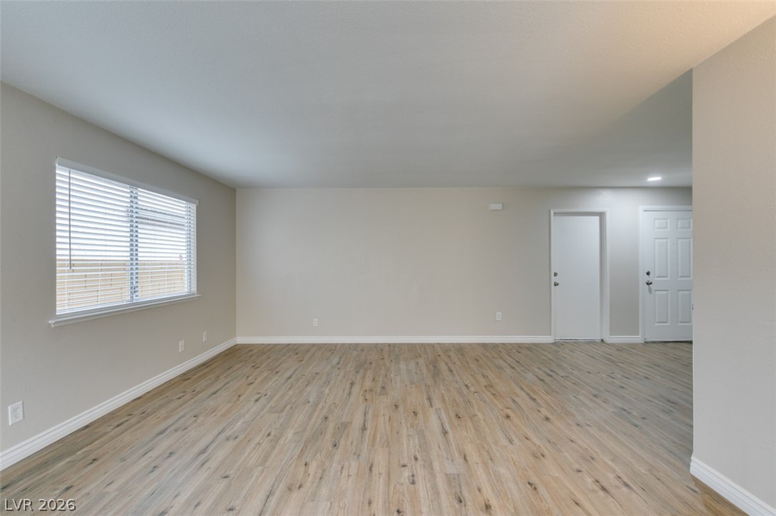 905 Scarlet Ridge Drive Las Vegas, NV 89128 - Photo 12 of 39 Unfurnished room with light wood-style floors and baseboards