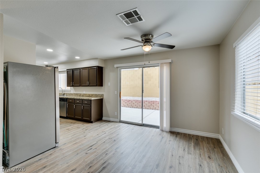 905 Scarlet Ridge Drive Las Vegas, NV 89128 - Photo 14 of 39 Kitchen featuring stainless steel appliances, dark wood finish cabinets, light wood-style floors, a ceiling fan, and recessed lighting