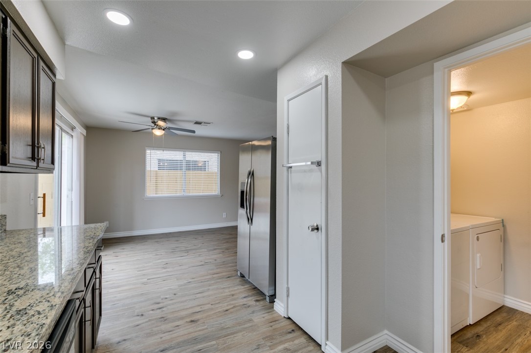 905 Scarlet Ridge Drive Las Vegas, NV 89128 - Photo 23 of 39 Kitchen with light wood-style flooring, stainless steel fridge, light stone counters, a ceiling fan, and recessed lighting