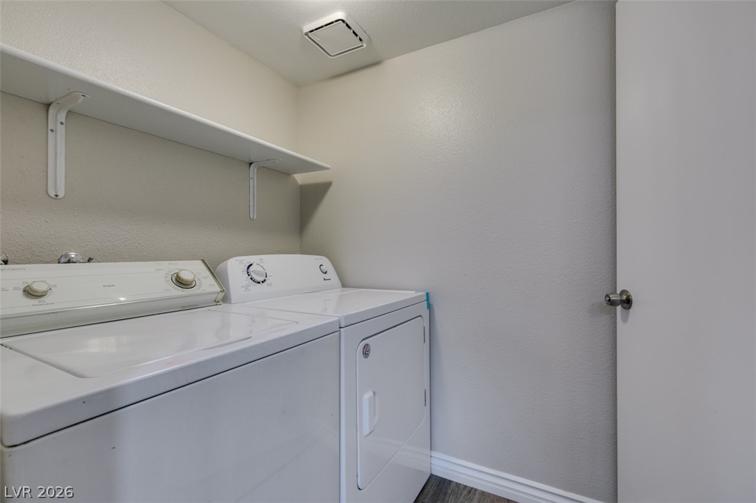 905 Scarlet Ridge Drive Las Vegas, NV 89128 - Photo 24 of 39 Laundry area with washer and clothes dryer and a textured wall