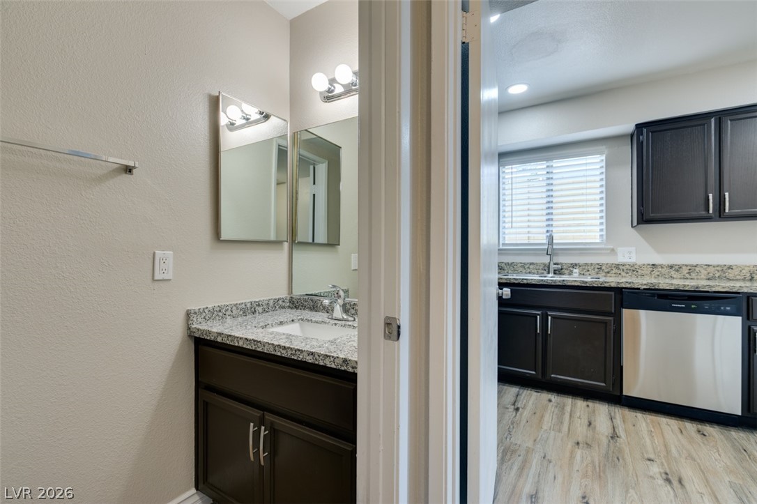 905 Scarlet Ridge Drive Las Vegas, NV 89128 - Photo 25 of 39 Bathroom featuring vanity, a textured wall, and light wood finished floors