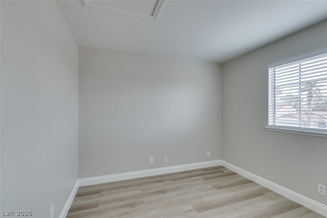 905 Scarlet Ridge Drive Las Vegas, NV 89128 - Photo 27 of 39 Unfurnished room with light wood-type flooring and baseboards