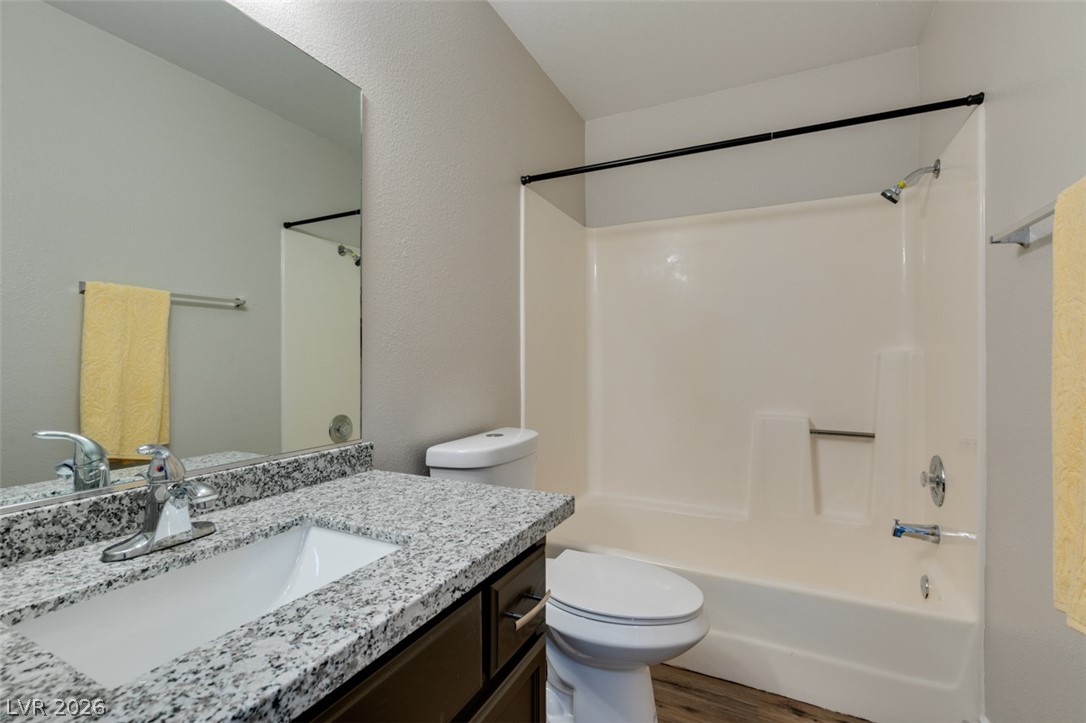 905 Scarlet Ridge Drive Las Vegas, NV 89128 - Photo 28 of 39 Bathroom with vanity, shower / tub combination, light wood-style floors, and a textured wall