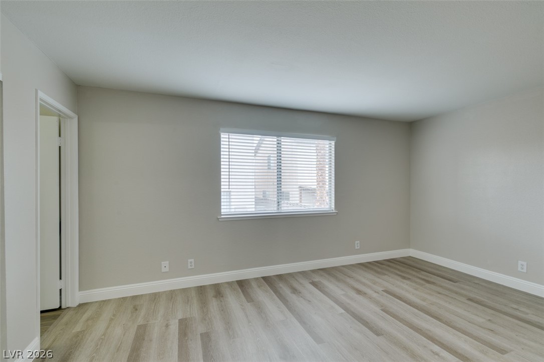 905 Scarlet Ridge Drive Las Vegas, NV 89128 - Photo 29 of 39 Spare room featuring light wood-style flooring and baseboards