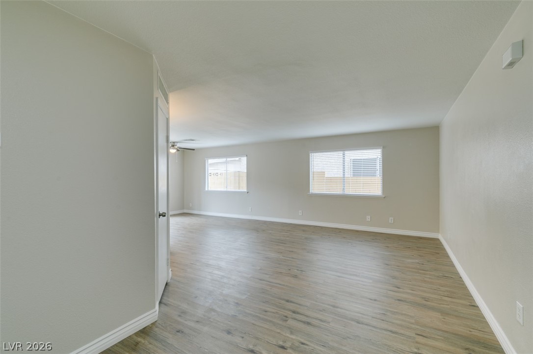 905 Scarlet Ridge Drive Las Vegas, NV 89128 - Photo 3 of 39 Spare room with light wood-style flooring and a ceiling fan