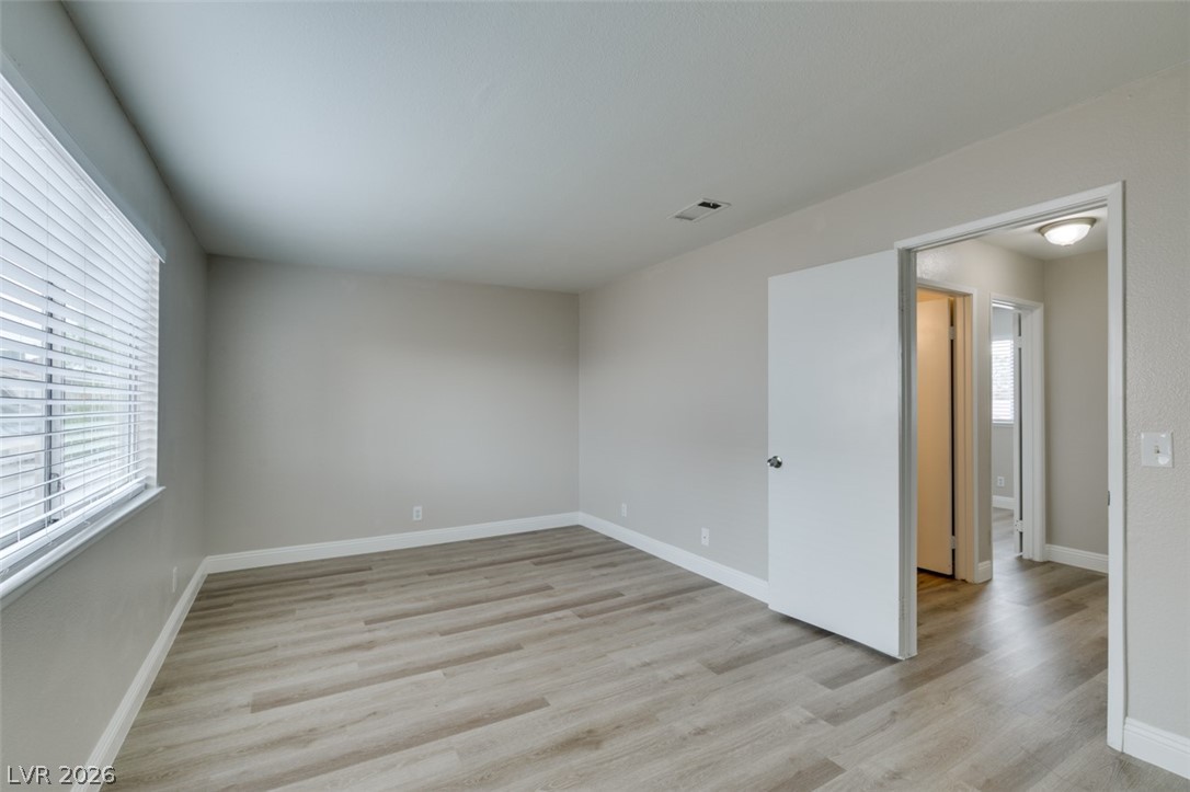 905 Scarlet Ridge Drive Las Vegas, NV 89128 - Photo 30 of 39 Empty room with light wood-style flooring and baseboards