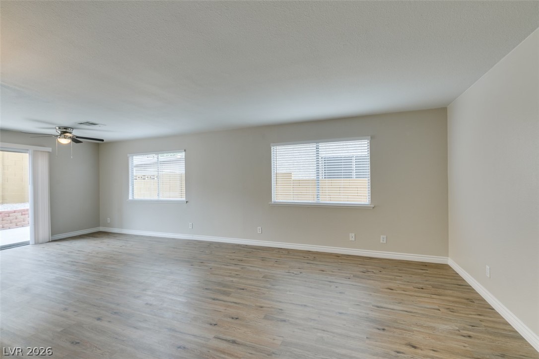 905 Scarlet Ridge Drive Las Vegas, NV 89128 - Photo 4 of 39 Empty room with light wood finished floors, plenty of natural light, and a ceiling fan