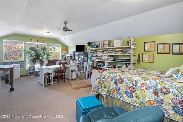 a bedroom with furniture and a large window