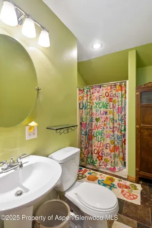 a bathroom with a sink mirror vanity and toilet