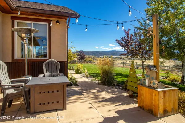 a view of a patio with a table and chairs