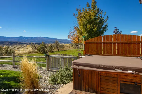 a view of a backyard with wooden fence