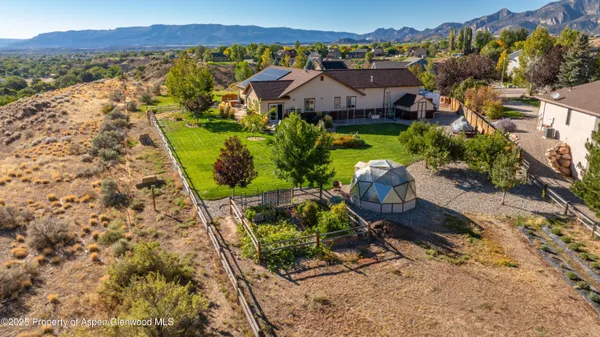 a aerial view of a house with a garden and lake view