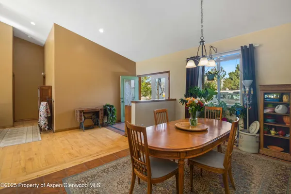 a dining room with furniture and window