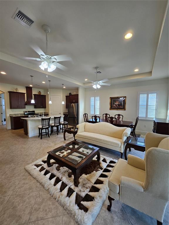 1283 Manado Drive Naples, FL 34113 - Photo 11 of 48 a living room with lots of furniture and kitchen view