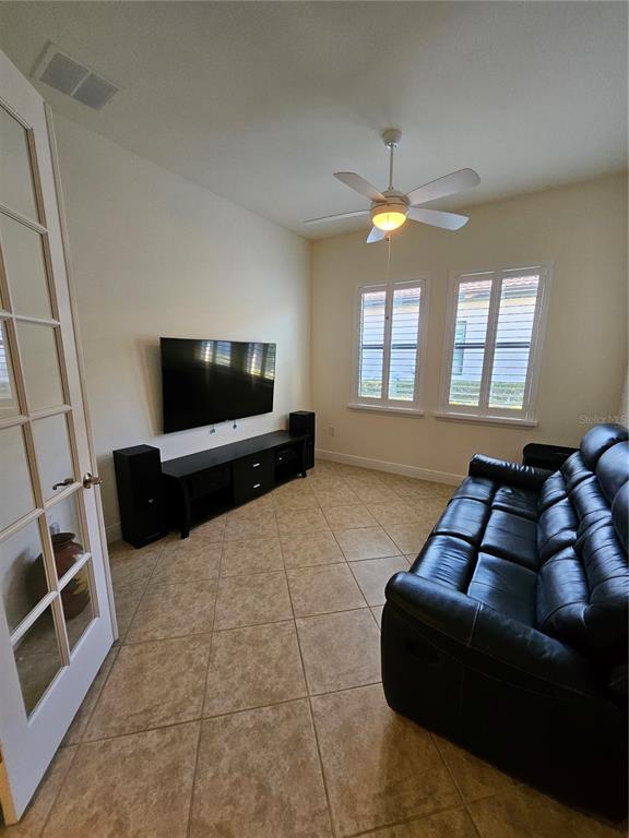 1283 Manado Drive Naples, FL 34113 - Photo 12 of 48 a living room with furniture and a flat screen tv