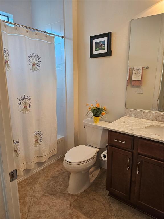 1283 Manado Drive Naples, FL 34113 - Photo 14 of 48 a bathroom with a granite countertop toilet a sink and a shower