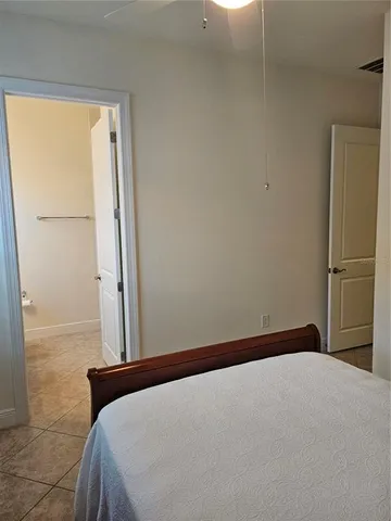 a bedroom with a bed and a cabinet