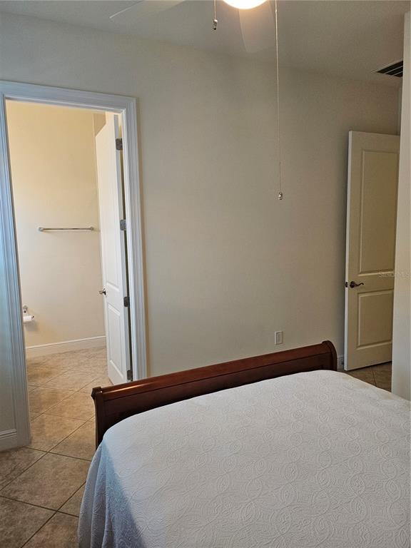 1283 Manado Drive Naples, FL 34113 - Photo 18 of 48 a bedroom with a bed and a cabinet