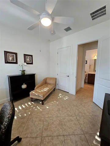 a living room with a couch and a potted plant on a dresser