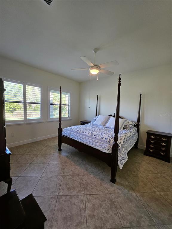 1283 Manado Drive Naples, FL 34113 - Photo 23 of 48 a bedroom with a bed and wooden floor