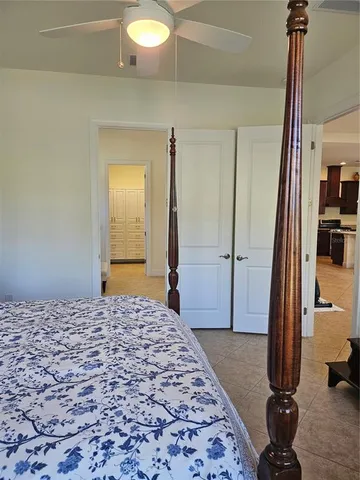 a bedroom with a bed and a mirror