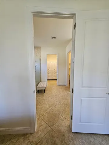 a view of a hallway with wooden floor and closet