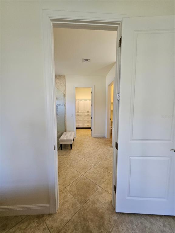 1283 Manado Drive Naples, FL 34113 - Photo 27 of 48 a view of a hallway with wooden floor and closet