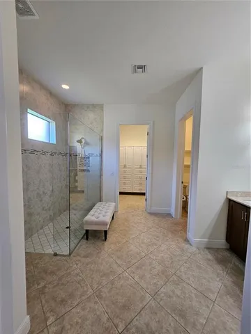 a view of a livingroom with a walk in closet and bathroom
