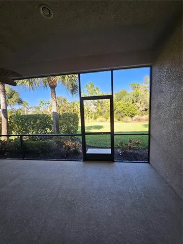 a view of a porch with furniture and garden