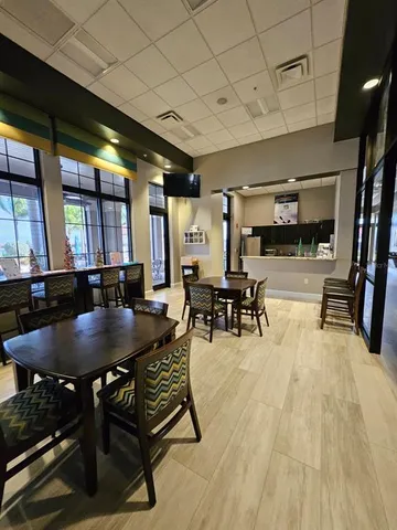 a dining room with furniture and wooden floor